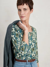 Load image into Gallery viewer, Cotton/bamboo 3/4 sleeve jersey shirt with scoop neck with keyhole detail. Greens & blues with white brushed floral print.