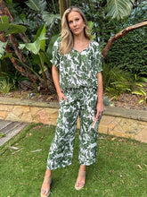 Load image into Gallery viewer, Hammock & Vine S/S shirt with shirred cuffs, high/low hem & button up front with V neck & collar in a stunning green ivy print on white.