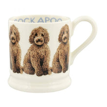 Load image into Gallery viewer, Emma Bridgewater Pottery 1/2 Pint Mug with hand painted Cockapoos around the outside and the word Cockapoo on the inside rim.
