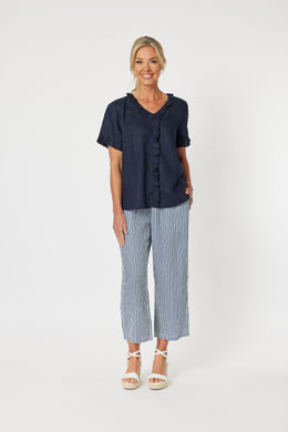 Linen V Neck Top with a fill around the neckline, front placket and sleeves. Short sleeves and curved hemline.