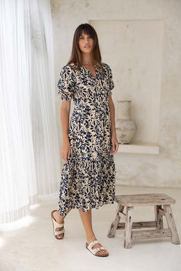 Maxi dress with V neck, button closure, short sleeves with gentle puff and elastic cuff. Removable waist tie, fitted at bust in a lightweight cotton.