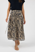 Load image into Gallery viewer, Cotton midi length skirt in navy floral on off white background. Wide rouched waistband, back zipper and fully lined.
