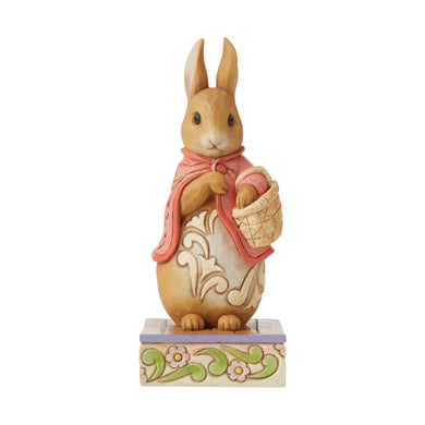 14.5cm high figurine of Beatrix Potters Flopsy in her pink cape and carrying a little basket.