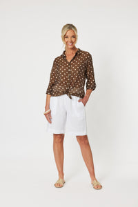 Classic style sheer shirt with long sleeves in a brown & white spot pattern.