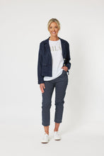 Load image into Gallery viewer, Navy cotton elastane flat front pants with small white bows printed all over them
